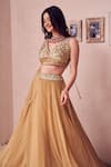 Shop_Swish By Dolcy And Simran_Gold Georgette Lining Marigold Layered Tassel Embellished Lehenga With Blouse _Online_at_Aza_Fashions