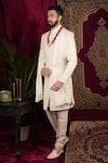 Sven suits_Ivory Raw Silk Embroidered Thread Floral Butti Sherwani Set _at_Aza_Fashions