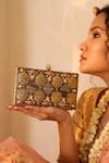 Buy_THE TAN CLAN_Gold Stone Arya Floral Carved Clutch _at_Aza_Fashions