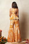 Shop_Vedika M_Orange Zari Tissue Crush Printed Abstract Halter Neck Peplum Top With Sharara _at_Aza_Fashions