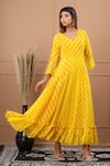 Buy_SUTI KAPDA_Yellow Chiffon V Neck Leheriya Pattern Flared Gown _at_Aza_Fashions