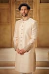 Shop_Vanshik_Gold Raw Silk Embroidered Tilla Floral Paisley Sherwani Pant Set _Online_at_Aza_Fashions