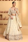 Buy_MeenaGurnam_Beige Blouse Net Woven Floral Sweetheart Neck Bloom Embroidered And Lehenga Set _Online_at_Aza_Fashions