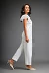 Shop_Deepika Arora_White Ponte Roma Embellished Leather Sphere Short Sleeves Belted Jumpsuit _at_Aza_Fashions