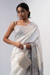 Buy_ADISEE_Ivory Ajrakh Handwoven Textured Wrist Bag _at_Aza_Fashions