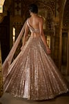 Shop_Seema Gujral_Rose Gold Net Embellished Sequins Asymmetric Neck Lehenga With Blouse _at_Aza_Fashions