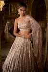 Seema Gujral_Rose Gold Net Embellished Sequins Asymmetric Neck Lehenga With Blouse _Online_at_Aza_Fashions