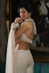 Seema Gujral_Cream Net Embroidered Crystal Halter Floral Cutwork Blouse Boot-cut Pant Set _Online_at_Aza_Fashions