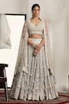 Shop_HOUSE OF SUPRIYA_Ivory Shimmer Net Embroidered 3d Flower Detailed Bridal Lehenga Blouse Set _at_Aza_Fashions