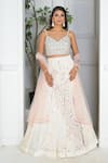 Buy_VRIDHI SOMAANI_Ivory Velvet Hand Embroidery Floral V Neck Daphne Lehenga Set _at_Aza_Fashions