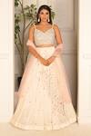 Buy_VRIDHI SOMAANI_Ivory Velvet Hand Embroidery Floral V Neck Daphne Lehenga Set 