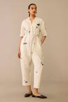 Buy Ampm Ivory Linen, Faux Leather Brooches, Embroidery Placed Flower Pattern Jumpsuit at Aza Fashions Buy_Ampm_Ivory Linen, Faux Leather Brooches, Embroidery Placed Flower Pattern Jumpsuit_at_Aza_Fashions