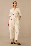 Ampm Ivory Linen, Faux Leather Brooches, Embroidery Placed Flower Pattern Jumpsuit at Aza Fashions Ampm_Ivory Linen, Faux Leather Brooches, Embroidery Placed Flower Pattern Jumpsuit_at_Aza_Fashions