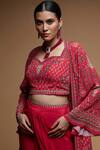 NIRRAAMYAA_Red Brocade, Bamboo Rhinestones Square Neck Embroidered Cape Dhoti Set _at_Aza_Fashions