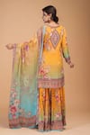 Shop_NIRRAAMYAA_Mustard Brocade, Georgette Rhinestones Round Neck Designer Yellow Kurta Set _at_Aza_Fashions