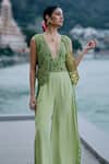 Shop_Surily G_Green Net, Crepe Sequins, Cut Work V-neck Designer Jumpsuit _at_Aza_Fashions