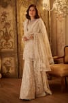 Buy_Seema Gujral_Ivory Net Pearls, Tassels Round Neck Floral Embroidered Sharara Set _at_Aza_Fashions