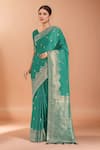 Buy_Samyukta Singhania_Turquoise Zari V-neck Woven Banarasi Saree With Blouse _at_Aza_Fashions