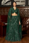 Buy_Istya_Emerald Green Net Sequins, Embroidery V-neck Fishcut Lehenga Set _at_Aza_Fashions