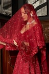 Istya_Red Net Sequins, Embroidery Plunge Neck Bridal Lehenga Set _at_Aza_Fashions