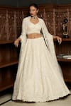 Buy_Istya_Ivory Net Sequins, Pearls, Beads, Embroidery Sweetheart Embellished Lehenga Set _at_Aza_Fashions