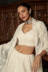 Istya_Ivory Net Sequins, Pearls, Beads, Embroidery Sweetheart Embellished Lehenga Set _Online_at_Aza_Fashions