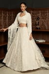 Buy_Istya_Ivory Net Sequins, Pearls, Beads, Embroidery Sweetheart Embellished Lehenga Set _Online_at_Aza_Fashions