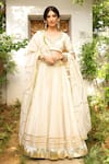 Buy_Sanam_Ivory Chanderi Mirrors, Zari, Gota Patti V-neck Embroidered Lehenga Set _at_Aza_Fashions