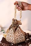 Buy_The Tan Clan_Gold Sequins, Beads, Pearls, Tassels Yana Lotus Potli With Handle _at_Aza_Fashions