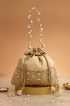 Buy_Amyra_Cream Cut Work, Pearls, Tassels, Embroidery Geet Brocade Embellished Potli - _at_Aza_Fashions