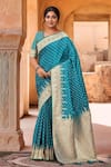 Buy_Samyukta Singhania_Turquoise Silk, Brocade Zari Sweetheart Neck Floral Woven Saree With Blouse _at_Aza_Fashions