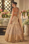 Shop_Isa By Dolly Wahal_Gold Net Sequins, Crystals, Embroidery Halter Neck Zara Embellished Lehenga Set _at_Aza_Fashions