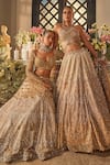 Isa By Dolly Wahal_Gold Net Sequins, Crystals, Embroidery Halter Neck Zara Embellished Lehenga Set _at_Aza_Fashions