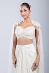 Samyukta Singhania Ivory Satin, Net Embroidery, Sequins Sweetheart Cape Blouse With Draped Skirt Online at Aza Fashions Samyukta Singhania_Ivory Satin, Net Embroidery, Sequins Sweetheart Cape Blouse With Draped Skirt _Online_at_Aza_Fashions