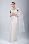 Buy Samyukta Singhania Ivory Satin, Net Embroidery, Sequins Sweetheart Cape Blouse With Draped Skirt at Aza Fashions Buy_Samyukta Singhania_Ivory Satin, Net Embroidery, Sequins Sweetheart Cape Blouse With Draped Skirt _at_Aza_Fashions