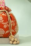 Shop_Amyra_Orange Embroidery, Zari, Tassels, Beads Taroob Handwoven Brocade Potli_Online_at_Aza_Fashions