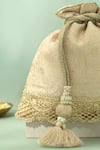 Buy_Amyra_Beige Tassels, Beads, Metallic Thread Nira Katan Silk Woven Potli Bag _Online_at_Aza_Fashions