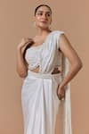 Shop Nitika Gujral Ivory Satin, Net, Shantoon Pearls, Crystals, Pre-draped Saree With Blouse Online at Aza Fashions Shop_Nitika Gujral_Ivory Satin, Net, Shantoon Pearls, Crystals, Pre-draped Saree With Blouse _Online_at_Aza_Fashions