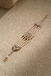 Shop Tarun Tahiliani Gold Plated Pearls, Diamonds Oval Centric Embellished Bracelet at Aza Fashions Shop_Tarun Tahiliani_Gold Plated Pearls, Diamonds Oval Centric Embellished Bracelet _at_Aza_Fashions