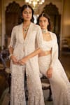 Seema Gujral_White Net Sequins, Stones, Tassels, Beads Open Embroidered Jacket Sharara Set _at_Aza_Fashions