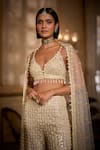 Seema Gujral_Cream Net Sequins, Pearls, Tassels, Fringe Sweetheart Embroidered Sharara Set _at_Aza_Fashions