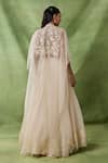 Shop_Awigna_Ivory Organza, Net Embroidery, Sequins, Beads, Freya Floral Cape Lehenga Set _at_Aza_Fashions