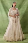 Buy_Awigna_Ivory Organza, Net Embroidery, Sequins, Beads, Freya Floral Cape Lehenga Set _at_Aza_Fashions