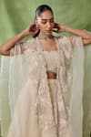 Shop_Awigna_Ivory Organza, Net Embroidery, Sequins, Beads, Freya Floral Cape Lehenga Set _Online_at_Aza_Fashions