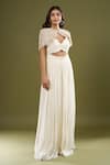 Couture By Niharika Ivory Sweetheart , Round Pleated Jumpsuit With Cape at Aza Fashions Couture By Niharika_Ivory Sweetheart , Round Pleated Jumpsuit With Cape _at_Aza_Fashions