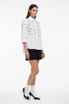 Studio Moda India White Cotton Collared Embellished Eyelet U-hem Shirt Online at Aza Fashions Studio Moda India_White Cotton Collared Embellished Eyelet U-hem Shirt _Online_at_Aza_Fashions