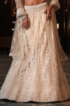 Nikunj By NIIDHI BAJAJ_Cream Net Embroidery, Pearls, Tassels Sweetheart Neck Noorani Lehenga Set _Online_at_Aza_Fashions