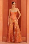 Buy_Label Astha Chhabra_Orange Organza Stones, Mirrors Bandeau Neck Embroidered Corset And Sharara Set _at_Aza_Fashions