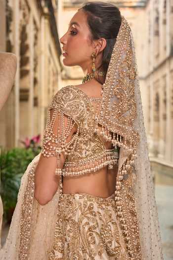 Buy_Seema Gujral_Beige Net Embroidery, Pearls, Sequins, Tassels Sweetheart Bridal Lehenga Set _Online_at_Aza_Fashions