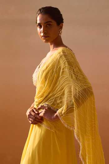 Shop_Nitika Gujral_Yellow Georgette, Net V-neck Pre-draped Saree With Blouse _Online_at_Aza_Fashions